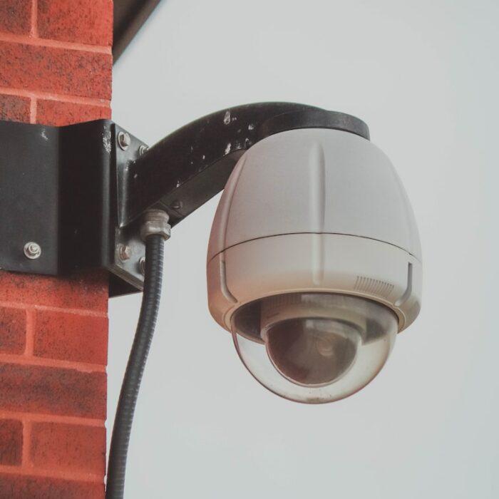 a security camera attached to a brick wall